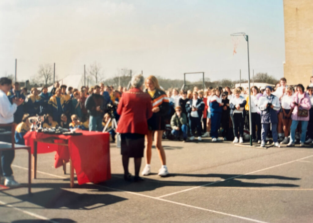 Trophy ceremony at a netball court.