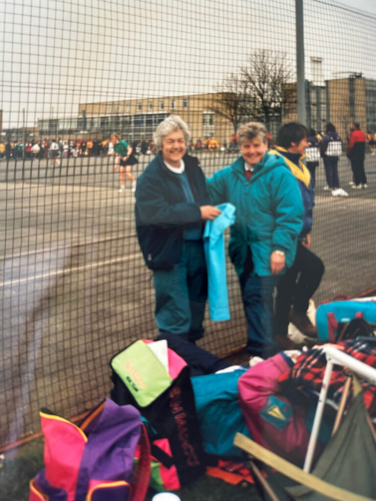 GMCNA ladies watching a netball match.