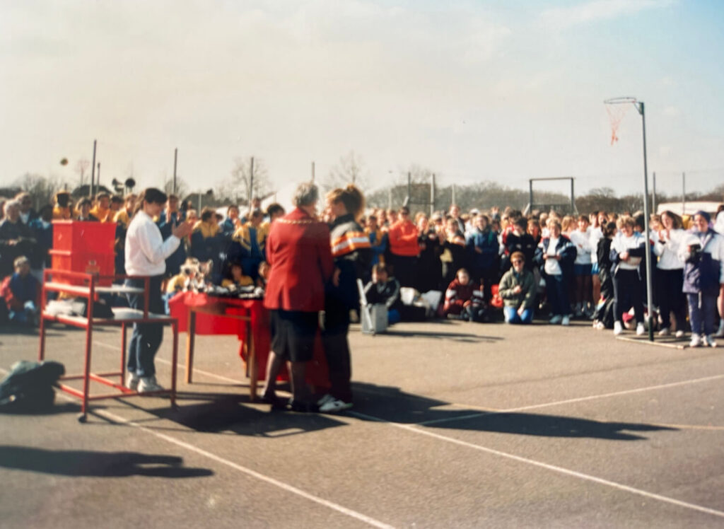 Trophy ceremony at a netball court.