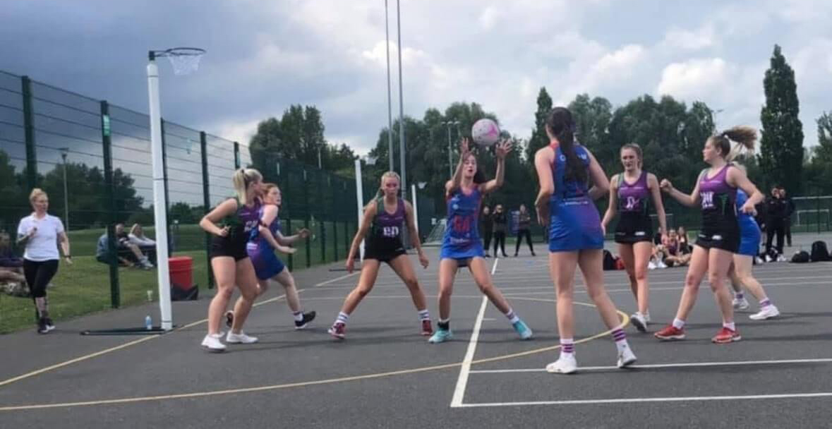 Netball competition outdoors.
